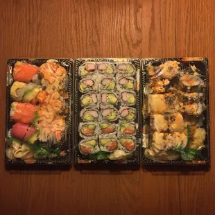three trays of sushi