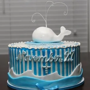 a blue and white cake with a whale on top
