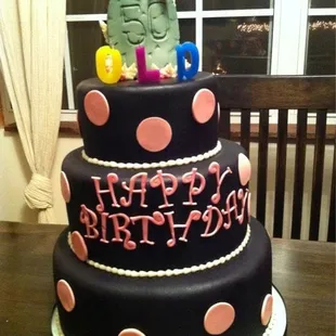 a black and pink birthday cake
