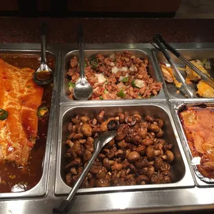 a variety of dishes in a buffet