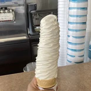 a hand holding an ice cream cone