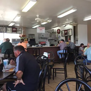 people sitting at tables in a restaurant