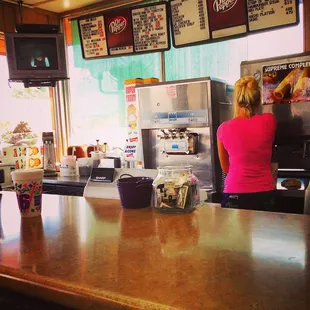 a woman at the counter of a fast food restaurant