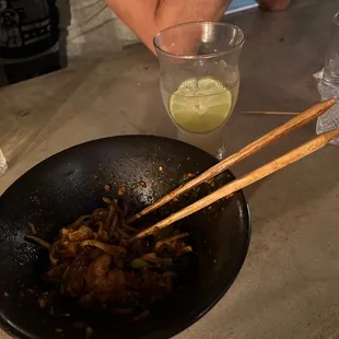 Half eaten Dan Dan noodles and half drunk Tokyo Mule.