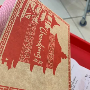 a box of chinese food on a tray
