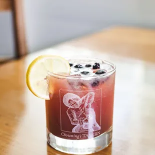 a drink with a lemon slice on the rim