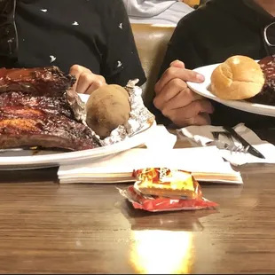 Beef ribs, potato on the left, bread &amp; salad (not pictured) on the right