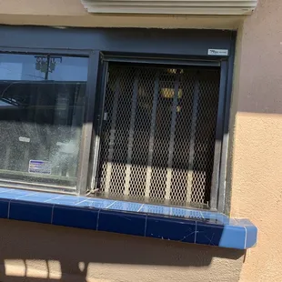 Bars over the drive thru window, almost thought they were closed