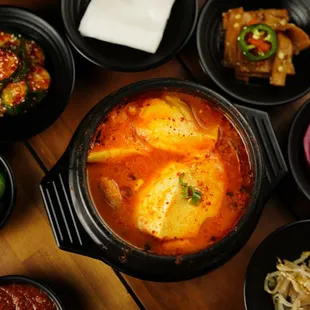 Tofu Soup (Sundubu-jjigae) served in a variety of flavors and spice levels: Including Kimchi, Seafood, Beef, Pork, Mushroom, and Mixed