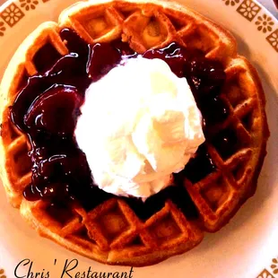  plate of waffles with whipped cream on top