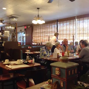 eople sitting at tables in a restaurant