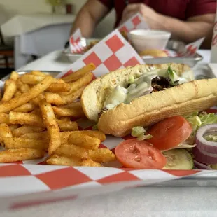 Ribeye po-boy with onions, bell peppers, and melted provolone cheese.