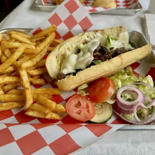 Ribeye po-boy with onions, bell peppers, and melted provolone cheese.