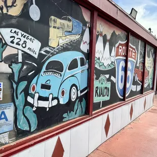 a blue vw beetle painted on the side of a building