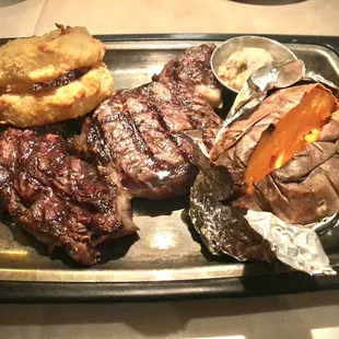 Prime Rib, sweet potato, house-made cinnamon butter on the side, with two steakhouse onion rings.