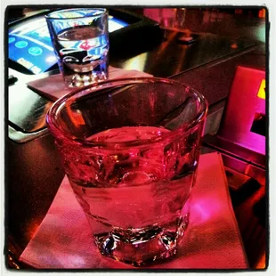 a glass of water on a napkin