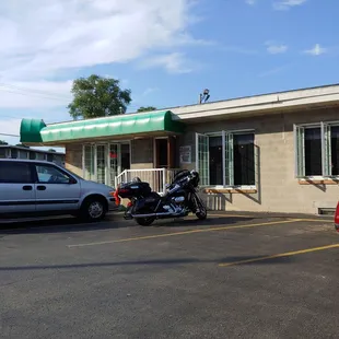 a motorcycle parked in front of a restaurant