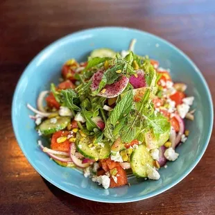 a blue bowl of salad