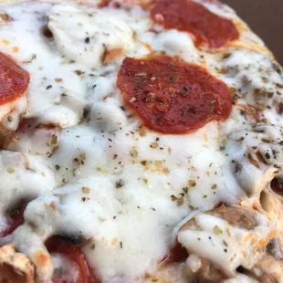 a hand holding a piece of pizza