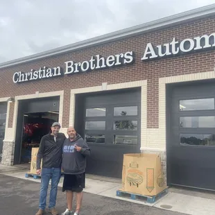 Jon and I are standing in front of the shop