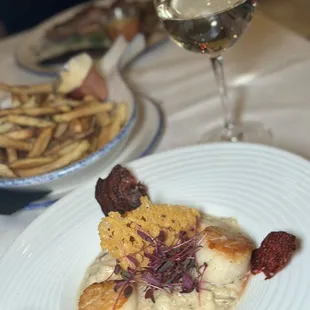 a plate of food and a glass of wine