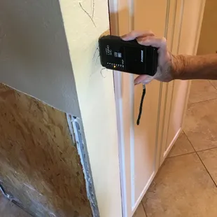 Checking how far up the wall the moisture traveled after CHRISTIE&apos;S replaced our ice maker.