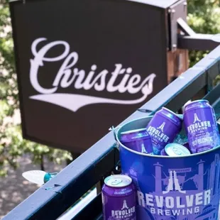 a bucket of purple beer and cans