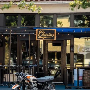 a motorcycle parked in front of a cafe