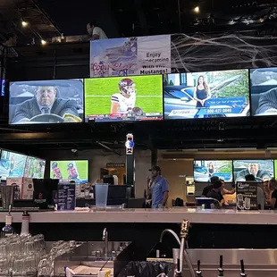a bar with multiple televisions in the background