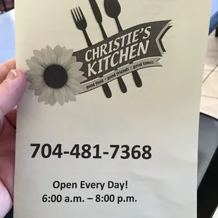 a hand holding a menu