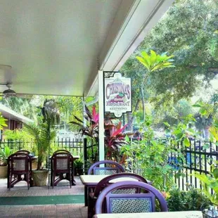 a patio with tables and chairs