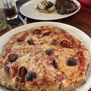 The pizzas are usually more specialized than this, but my wife just wanted pepperoni on hers.