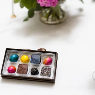a glass of wine and chocolates
