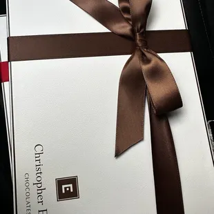a gift wrapped in chocolate ribbon