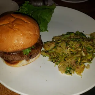 Mouthwatering Bison Burger with shaved brussel sprouts.