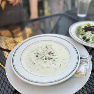 a bowl of soup and a plate of salad