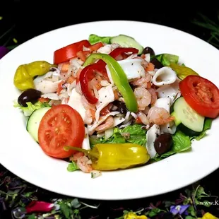 a white plate with a salad on it