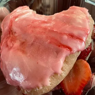 Strawberry filled heart shaped donut with fresh strawberries