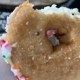 a half eaten donut with sprinkles