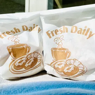 two bags of fresh daily donuts