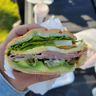 a person holding a sandwich