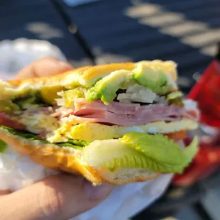 a person holding a sandwich