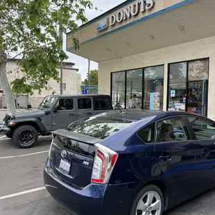 a car parked in front of a donut shop