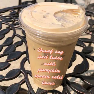 a cup of iced coffee on a table