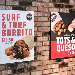 a brick wall with two posters on it