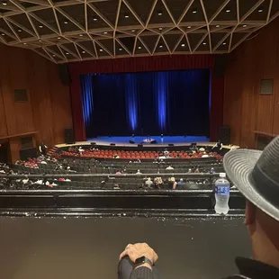 a man in a hat looking at a stage