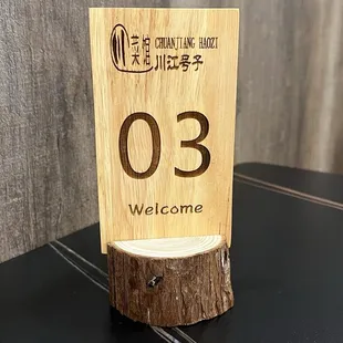 a wooden sign on a table