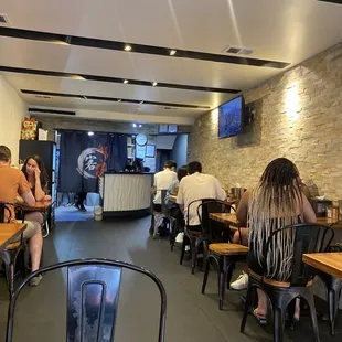 people sitting at tables in a restaurant