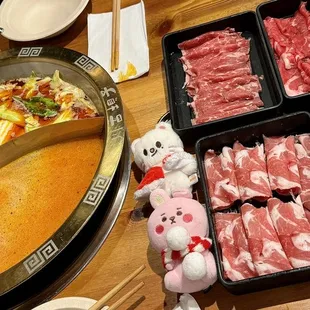 a variety of raw meats in trays