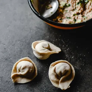 three dumplings and a bowl of soup